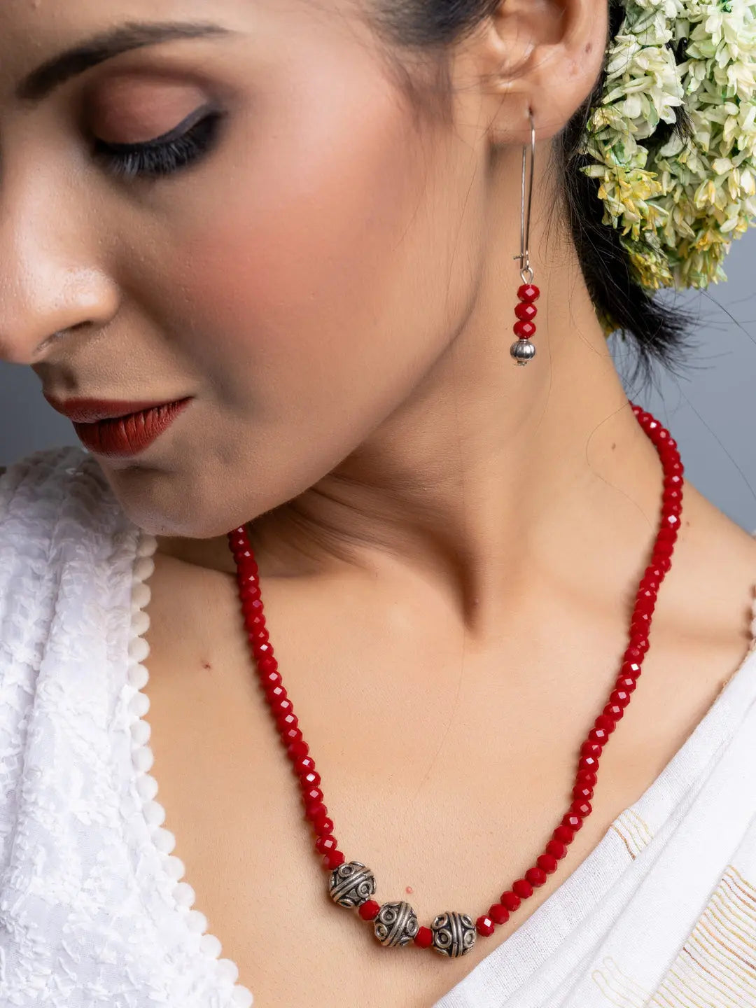 Handmade Red Crystal Necklace Set with silver beads worn by woman in white attire and floral hair accessory