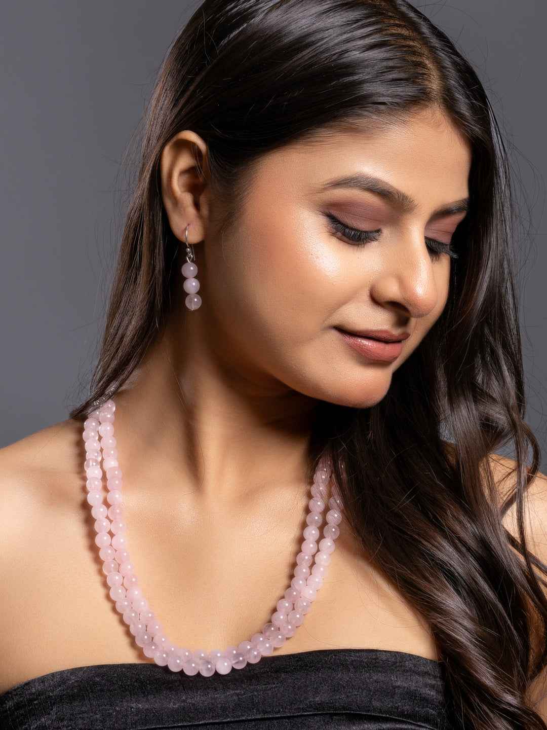Handmade rose quartz necklace set in soft pink color, featuring elegant beaded design with matching earrings.