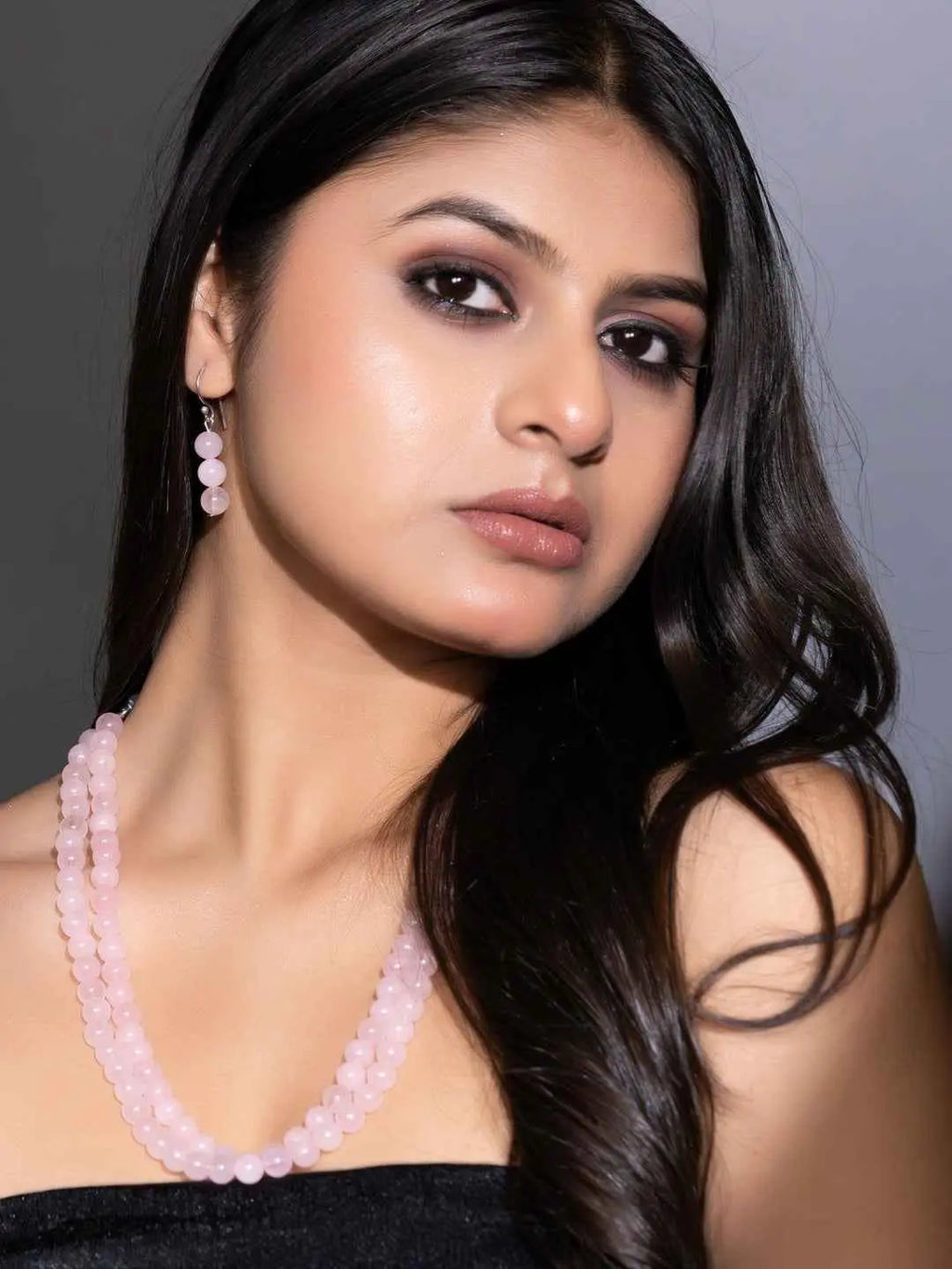 Handmade rose quartz necklace set in soft pink, featuring matching earrings for an elegant look