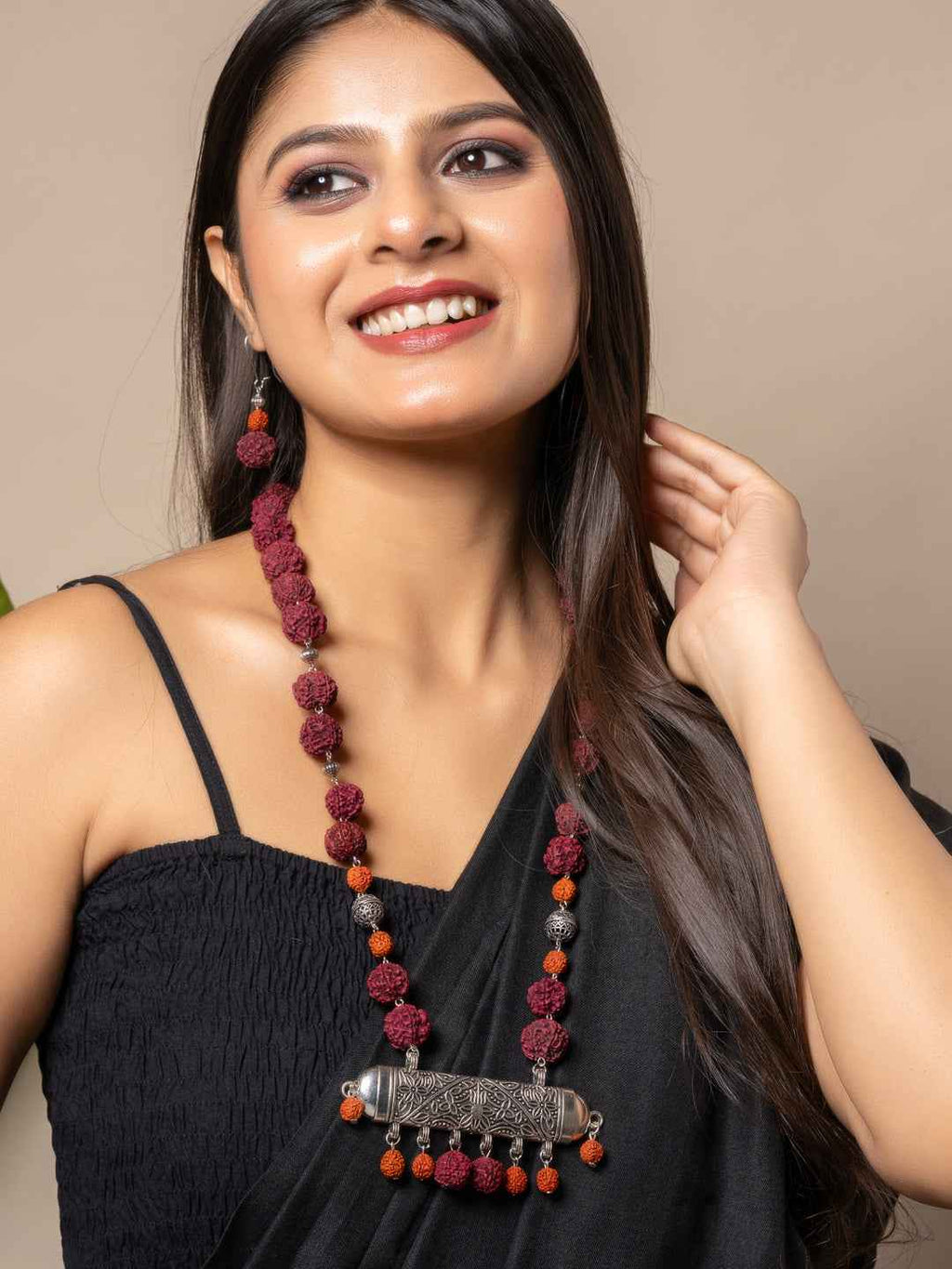 Handmade rudraksh necklace set in burgundy and silver with intricate metal accents, worn elegantly
