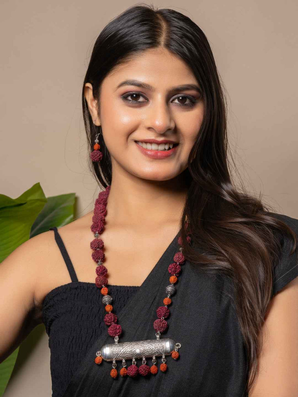 Handmade rudraksh necklace set in deep maroon with silver pendant, paired with matching earrings
