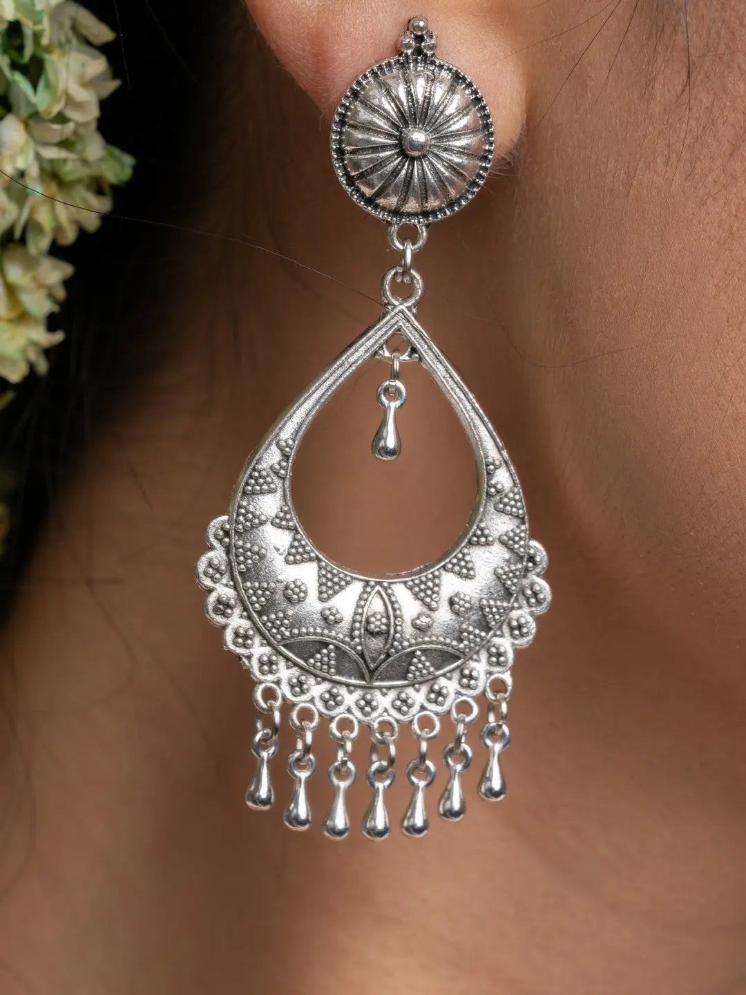 Oxidised silver chandbali earrings with intricate floral and dangling bead design