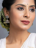 Oxidised silver jhumka earrings worn by woman with traditional floral hair accessory
