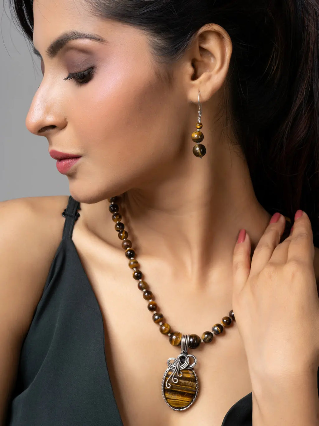 Woman wearing handmade tiger eye necklace with matching earrings from LOOK AND ADORN
