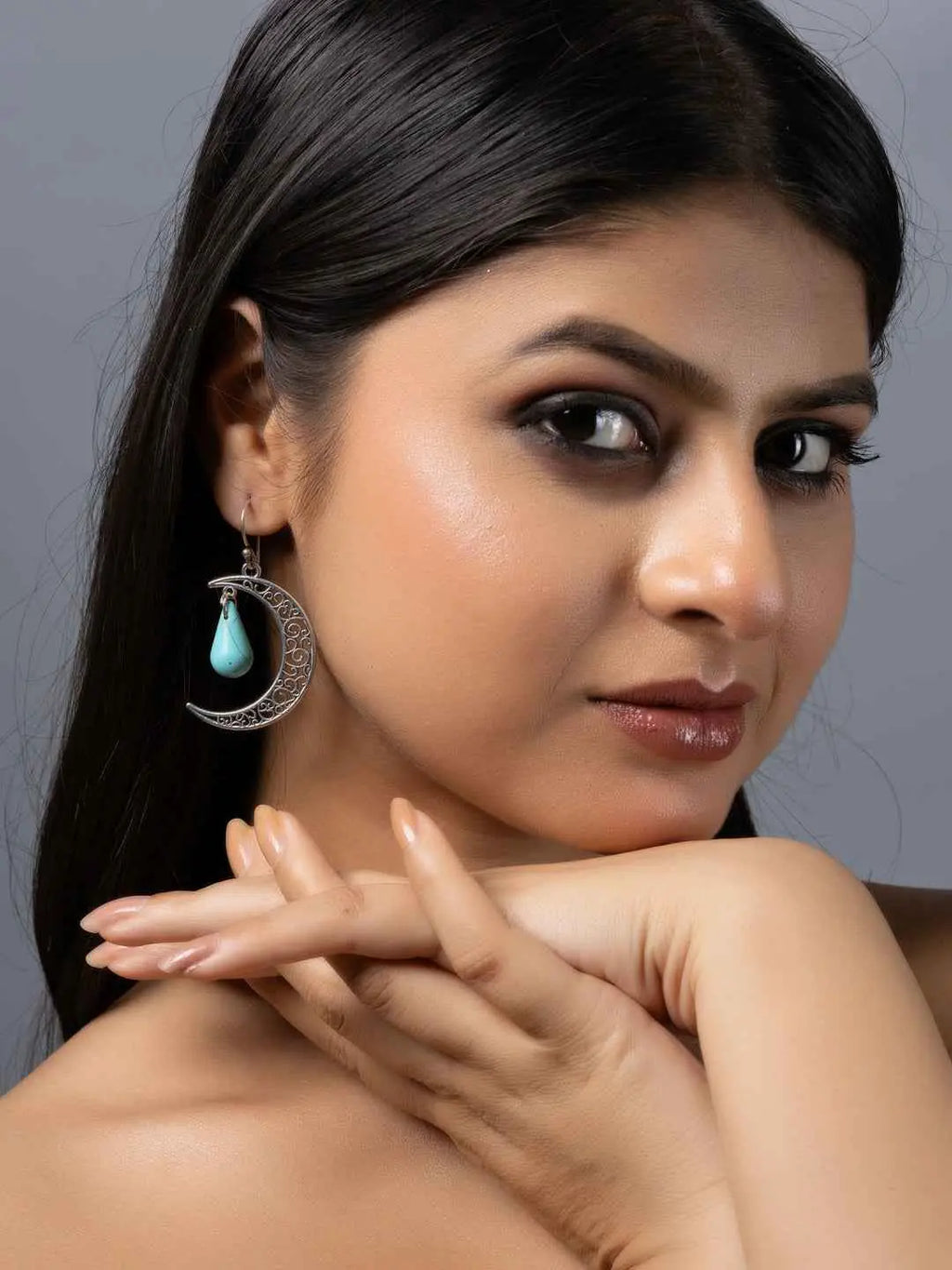 Handmade turquoise earrings featuring a crescent moon design with a delicate drop, perfect for elegant occasions