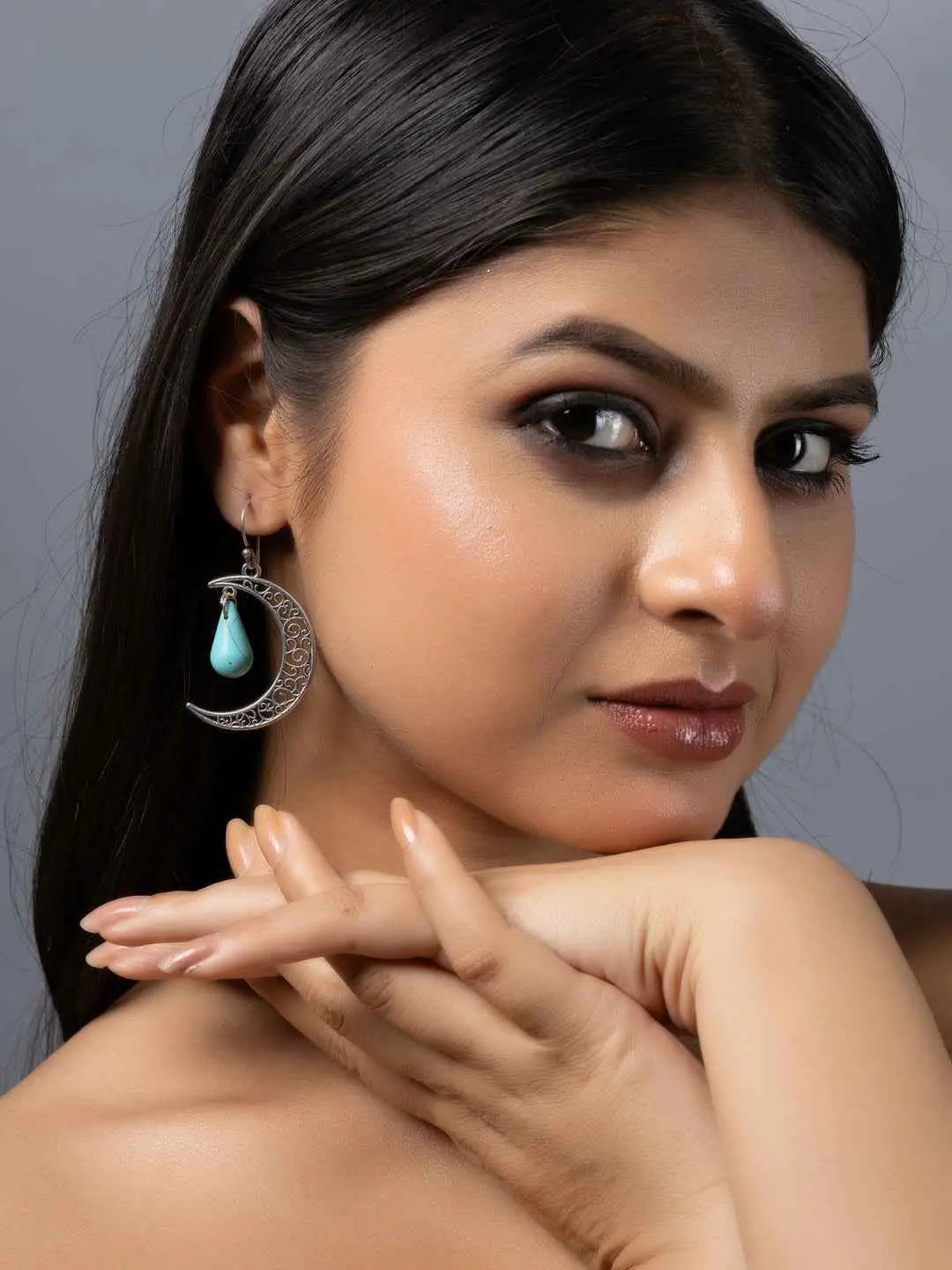 Handmade turquoise earrings featuring a crescent moon design with a delicate drop, perfect for elegant occasions