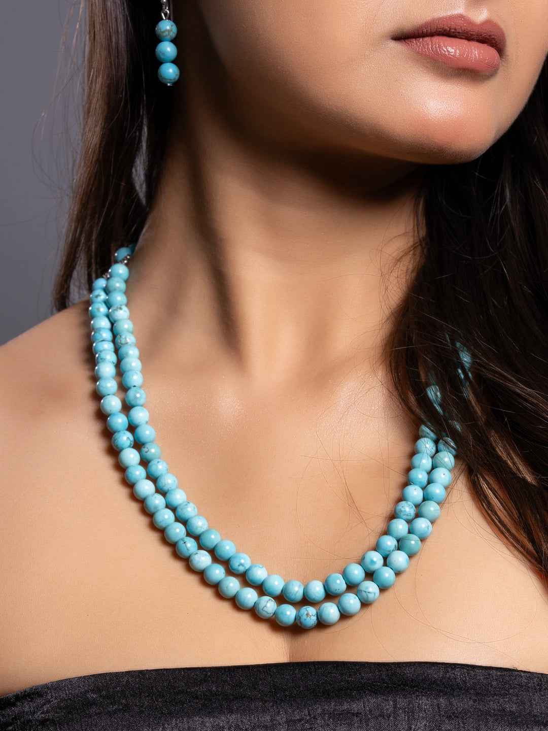 Turquoise necklace set featuring three layers of smooth turquoise beads with matching earrings