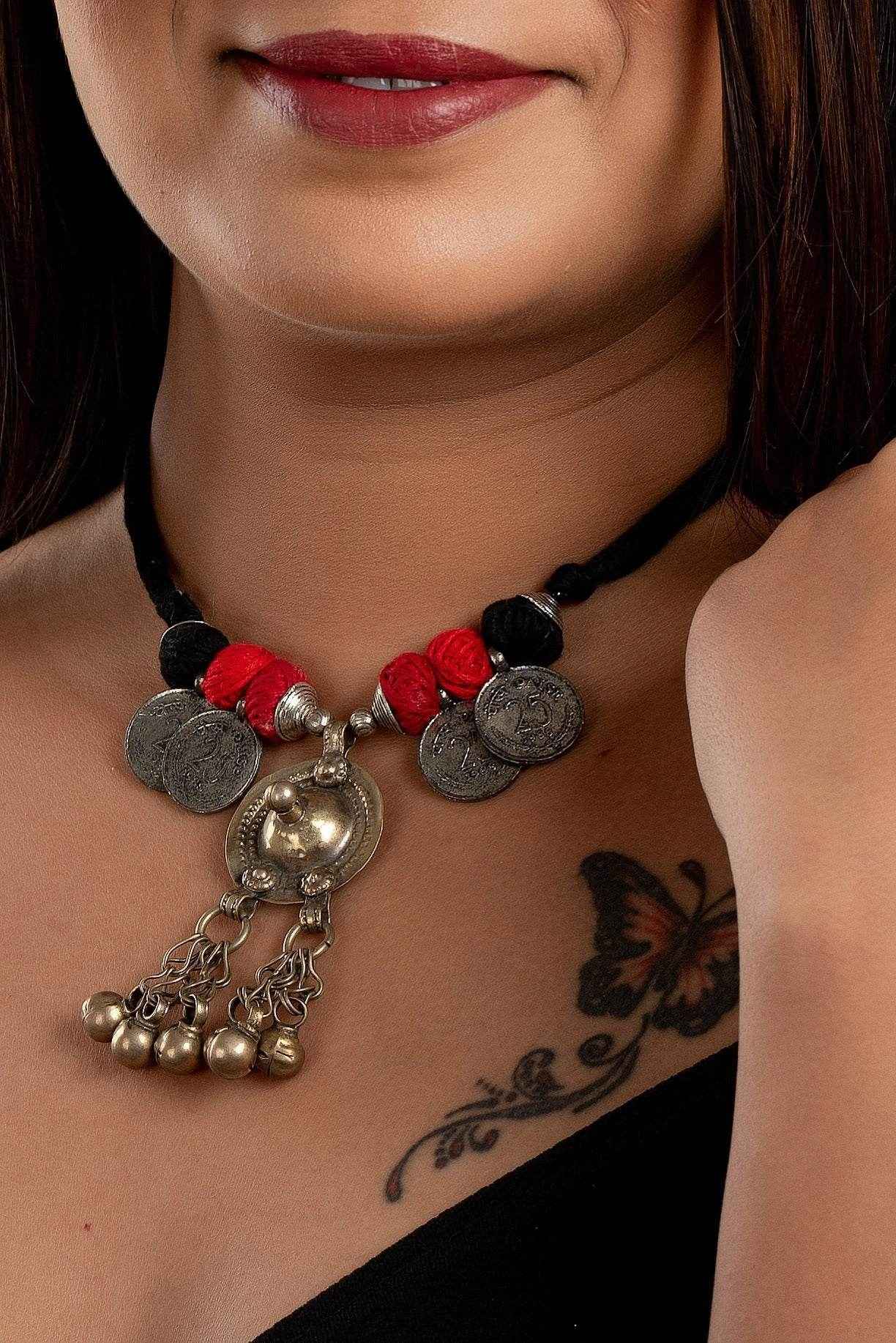 LOOK AND ADORN Afghani Necklace with silver coins and red thread worn on model's neck