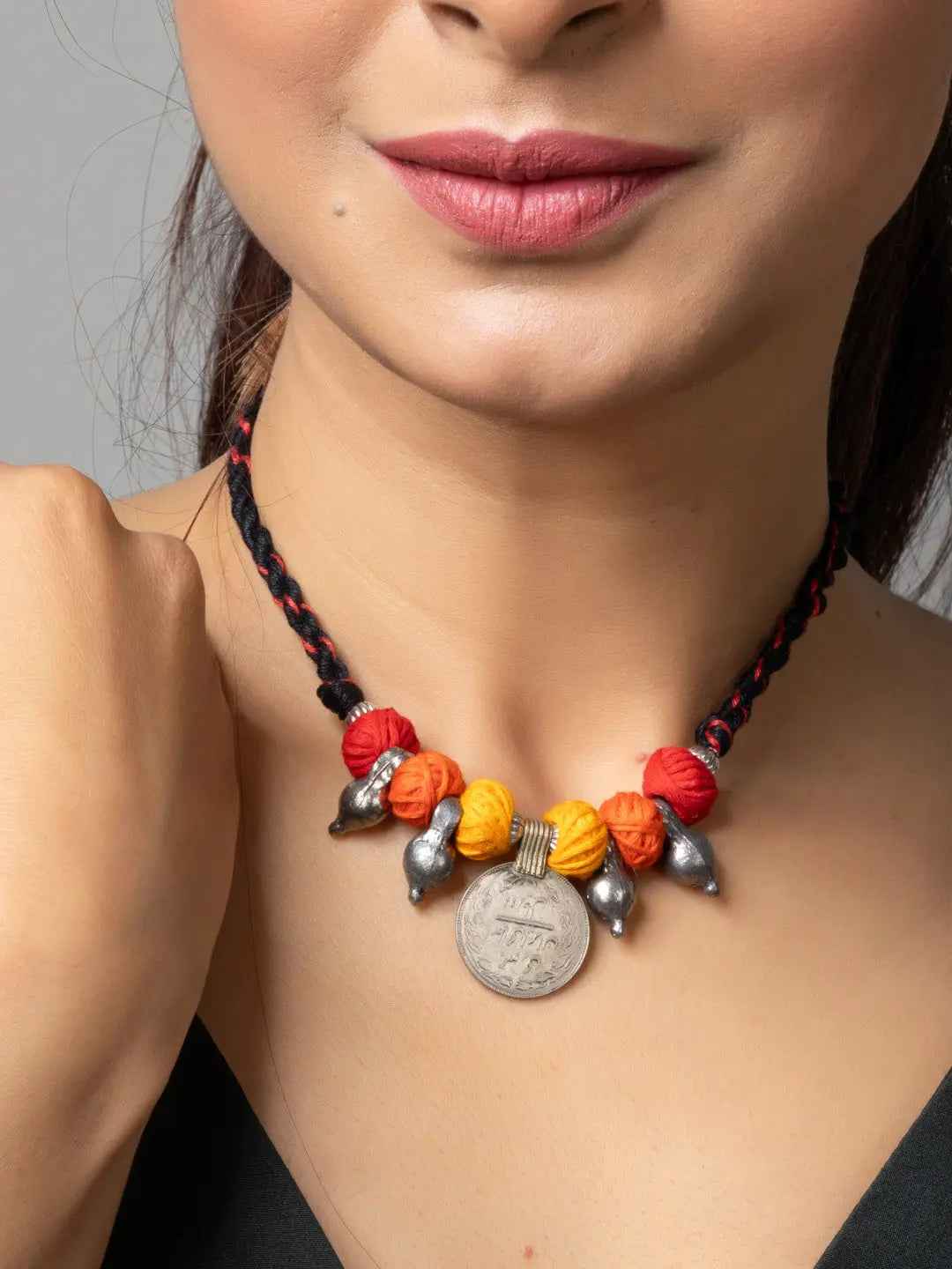 Afghani pendant necklace with colorful beads and antique coin on braided black cord
