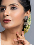 Oxidised silver jhumka earrings worn by woman with floral hair accessories from LOOK AND ADORN