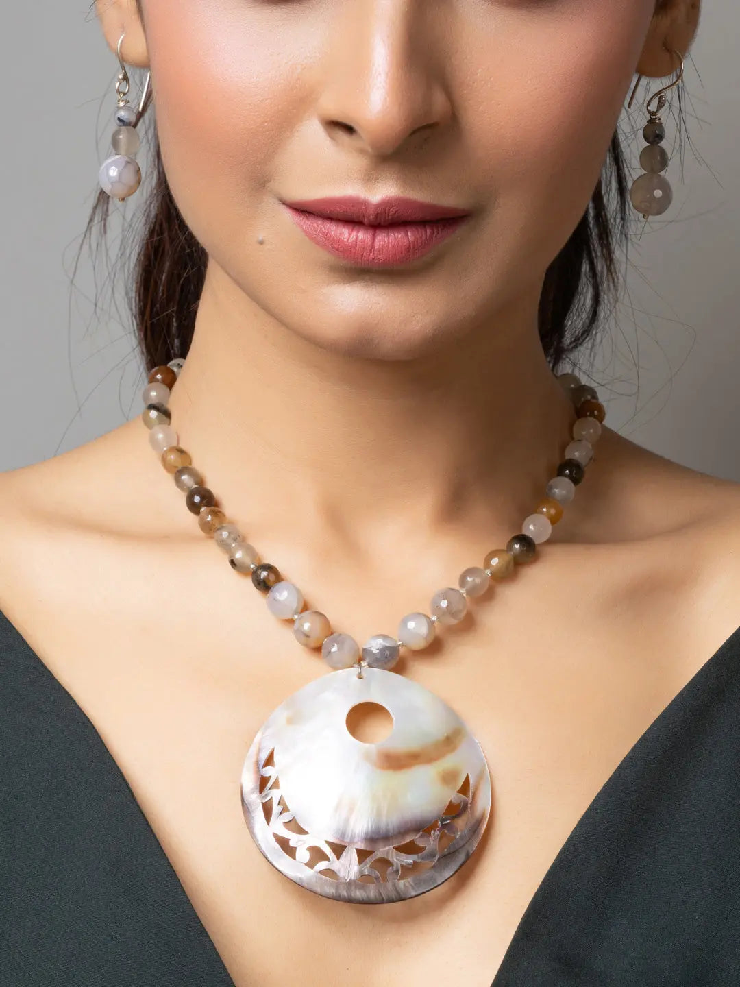 Handmade Mother of Pearl Pendant necklace with beaded chain worn on woman's neck