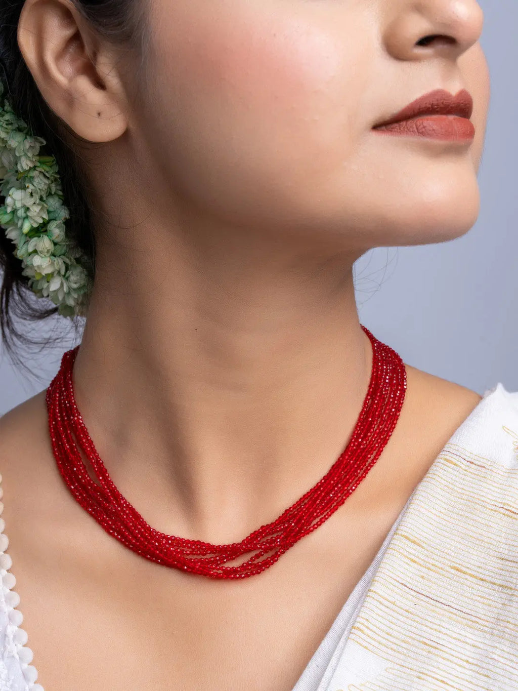 Handmade red crystal necklace with multiple strands worn by woman, elegant jewelry by LOOK AND ADORN